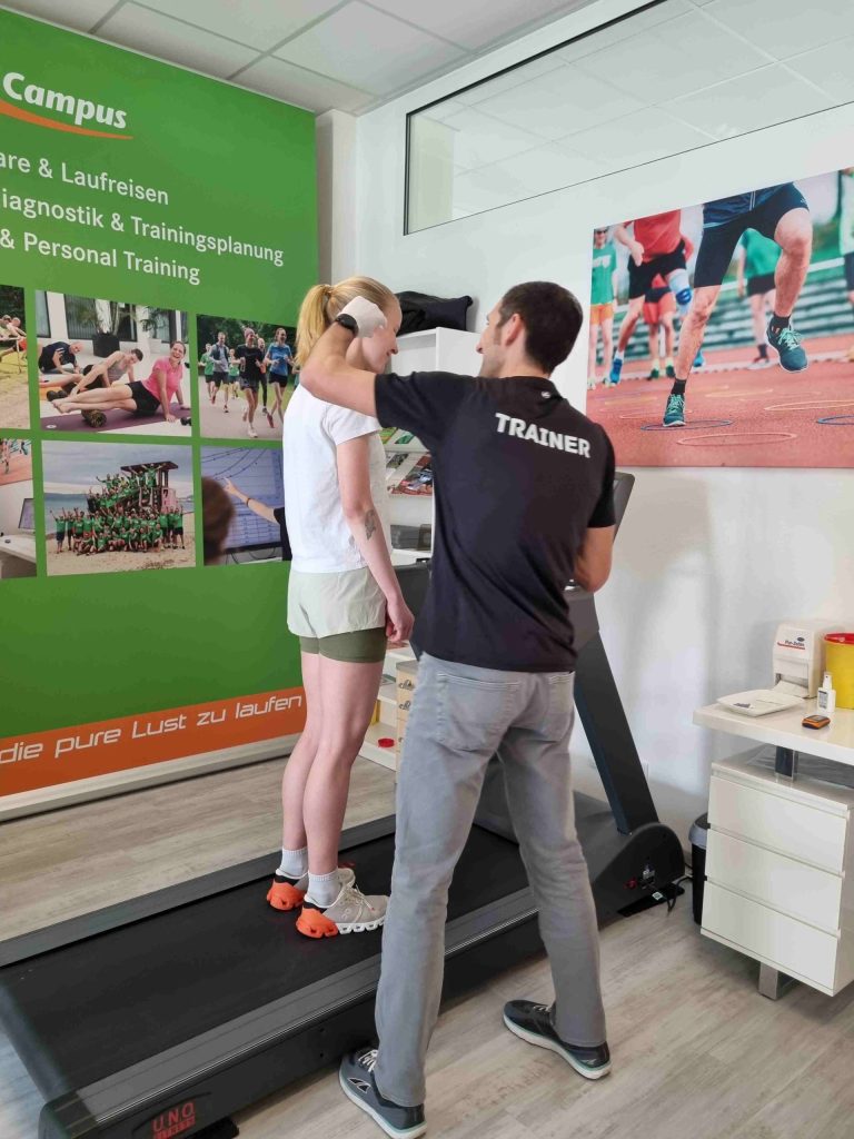 Trainer hilft beim Lauftraining